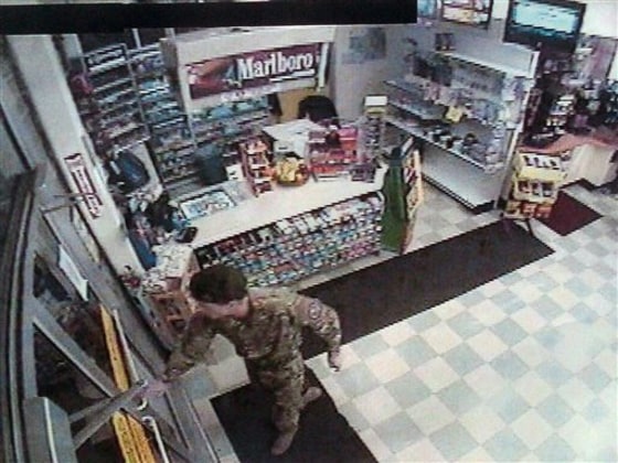 Security video image released by Oregon State Police on Wednesday, Jan. 26, shows a man identified as David Durham wearing camouflage clothing and a black beret in what appears to be a convenience store, about 30 minutes before Lincoln City police officer Steven Dodds was shot during a traffic stop Sunday night.